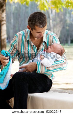 Everyday problems. The father with the newborn son in park