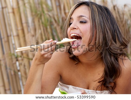 Beautiful woman eating rice