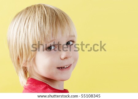 Portrait boy of preschool age on a yellow background