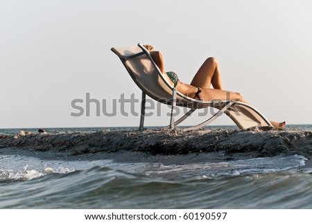 The girl in a hat having a rest on seacoast