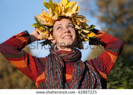 Lovely little woman with autumn wreath on her head