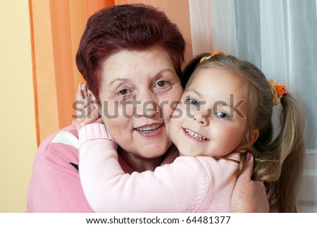 Closeup portrait of a grand daughter and grandmother smiling