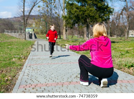 Mother with the son running on park