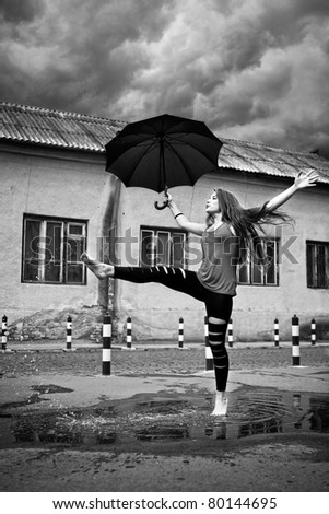 happy young woman running under rain