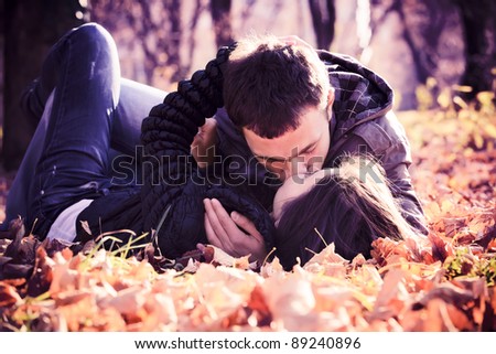 Kissing young couple in love in the autumn park