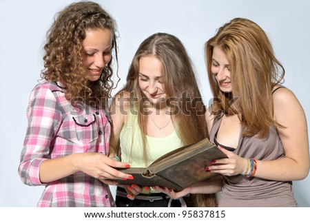 Portrait of smart students girls reading the book