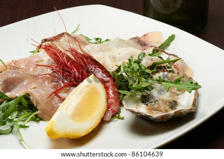 seafood appetizer with oyster, shrimp and arugula