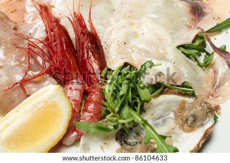 seafood appetizer with oyster, shrimp and arugula
