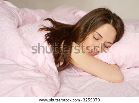 The girl sleeps on pink bed-clothes