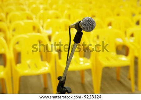 Microphone against yellow chairs