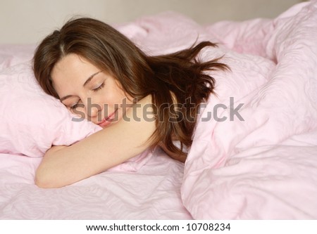 The girl sleeps on pink bed-clothes