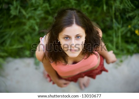 The young girl with blue eyes and dark hair looks in a shot, having lifted a head