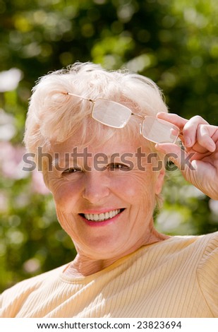 Portrait of the smiling elderly woman in the glasses