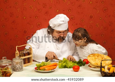 Chef cook teaching little girl to prepare salad