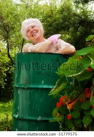 stock-photo-the-elderly-woman-washes-in-the-cask-51779575.jpg