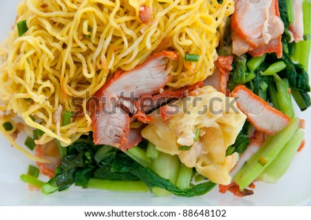 Egg chinese dry noodles with roast red pork, dumpling and vegeta
