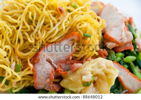 Egg chinese dry noodles with roast red pork, dumpling and vegeta