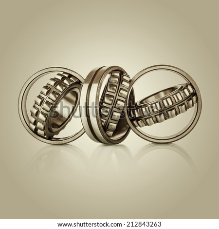Collection of different steel chromed shiny ball roller bearings on  retro vintage background with reflection effect, closeup