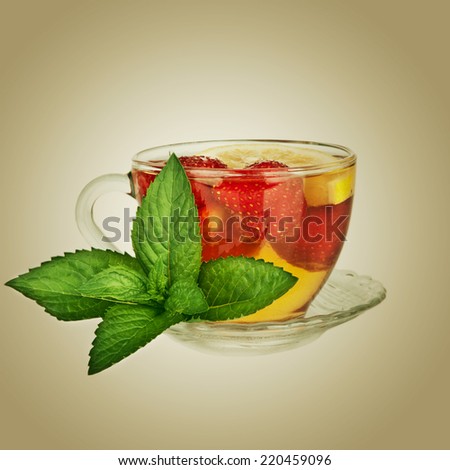Tea cup with strawberry and mint leaf