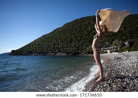 Beautiful Girl With Scarf on The Beach. Travel and Vacation. Freedom Concept. Full length portrait