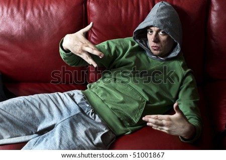 Bad Guy with hood on red sofa