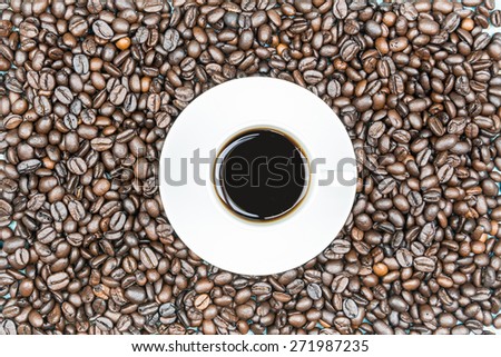 Cup of coffee with a brown beans background