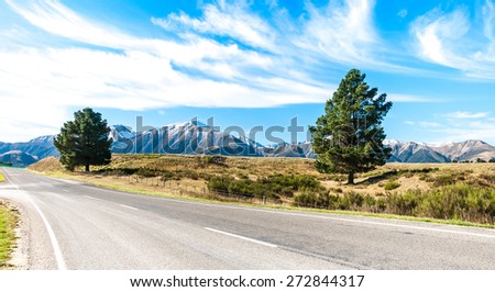 asphalt highway curve road to mountain cook New Zealand with cloud and sky