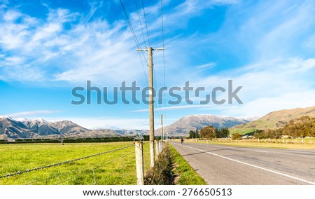 asphalt highway curve road to mountain cook New Zealand with cloud and sky