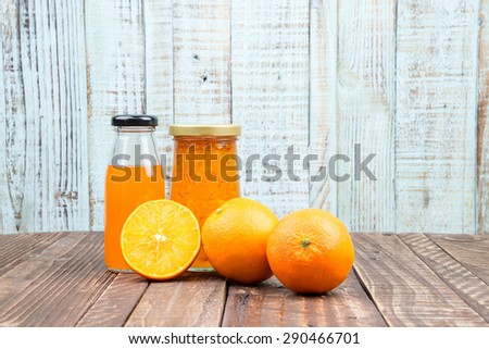 Fresh orange and juice on vintage wooden table background