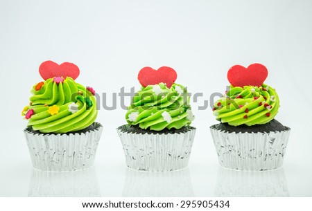 colorful cupcakes with beautiful decoration over white background