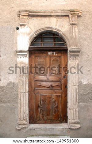 Old wooden door in Saint-Enimie village, Gorges du Tarn, France.