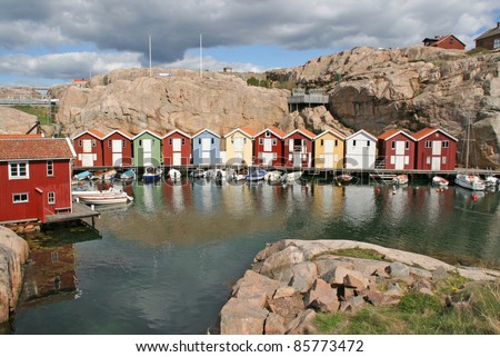 Row of colored swedish coastal houses and motorboats, smogen, sweden