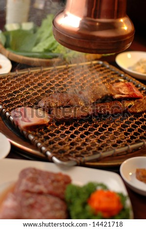 Steak cooking on fired flame grill in Restaurant