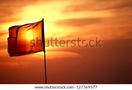 Sun behind the red flag.