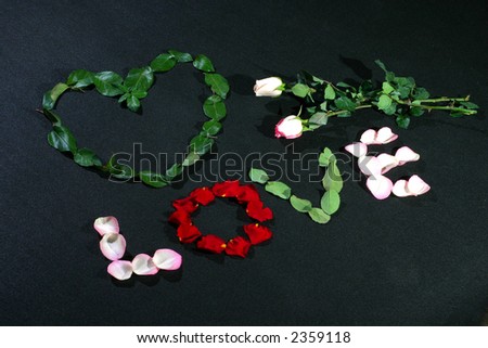 a heart and love made by rose petals