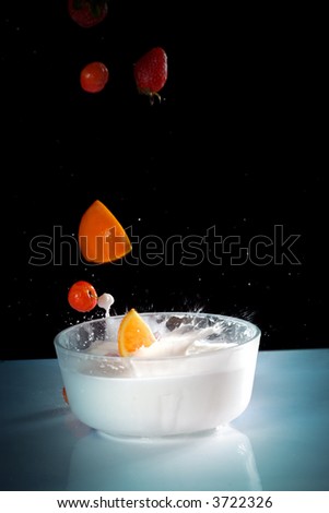 The fruits splash into glass of milk