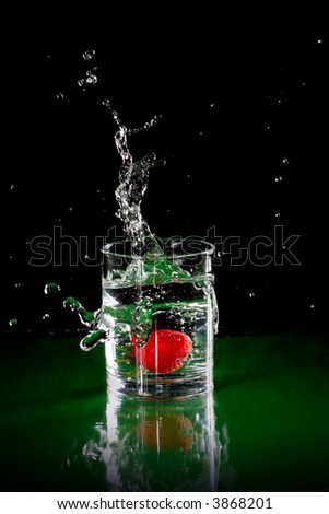 The fruits splash into glass of water