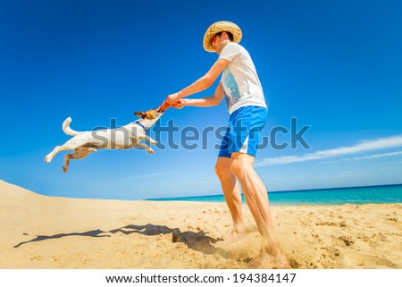dog catching a red frisbee with owner spinning around