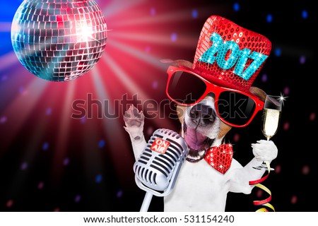 jack russell dog celebrating new years eve with champagne glass and singing out loud, isolated on dark black party nightlife club with retro old microphone