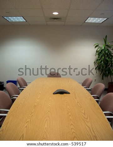 Vertical shot, looking down a long Board room table
