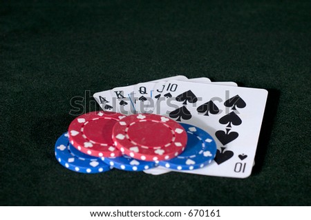 A royal Flush in spades, with some red and blue chips