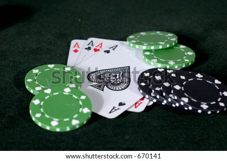 four Aces and  king, with black and green chips scattered.