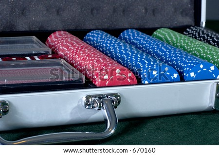 A complete set of poker chips in a case, with cards and dice