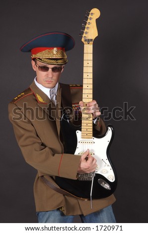 Portrait of a man dressed in a military uniform, playing an electric guitar