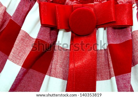 White and red cell textile texture with a red button and a bow on it/Cell textile texture