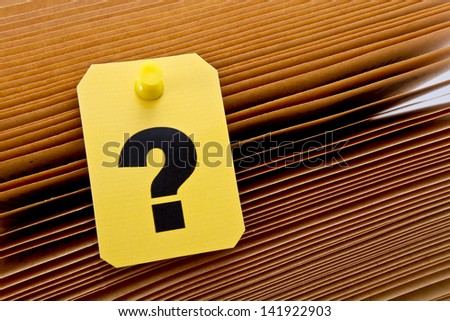 Yellow label with question mark sign on old book sheets/Question mark sign
