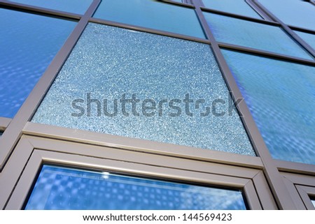 Modern building mirror glass wall with cracked glass on it.