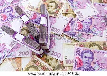 Ukrainian banknotes background with arrow shape made of money stacks. Money inflation concept.