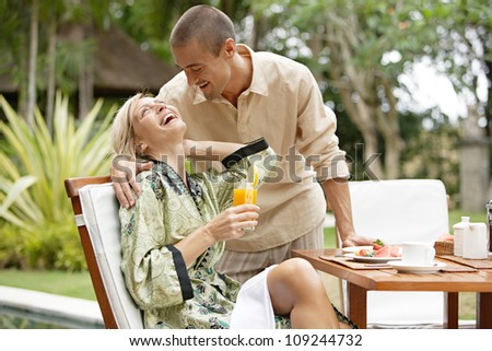 http://image.shutterstock.com/display_pic_with_logo/840583/109244732/stock-photo-young-couple-laughing-while-having-a-luxury-breakfast-in-a-tropical-garden-while-on-vacations-109244732.jpg