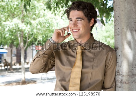 Portrait of a smart businessman having a phone conversation on his \